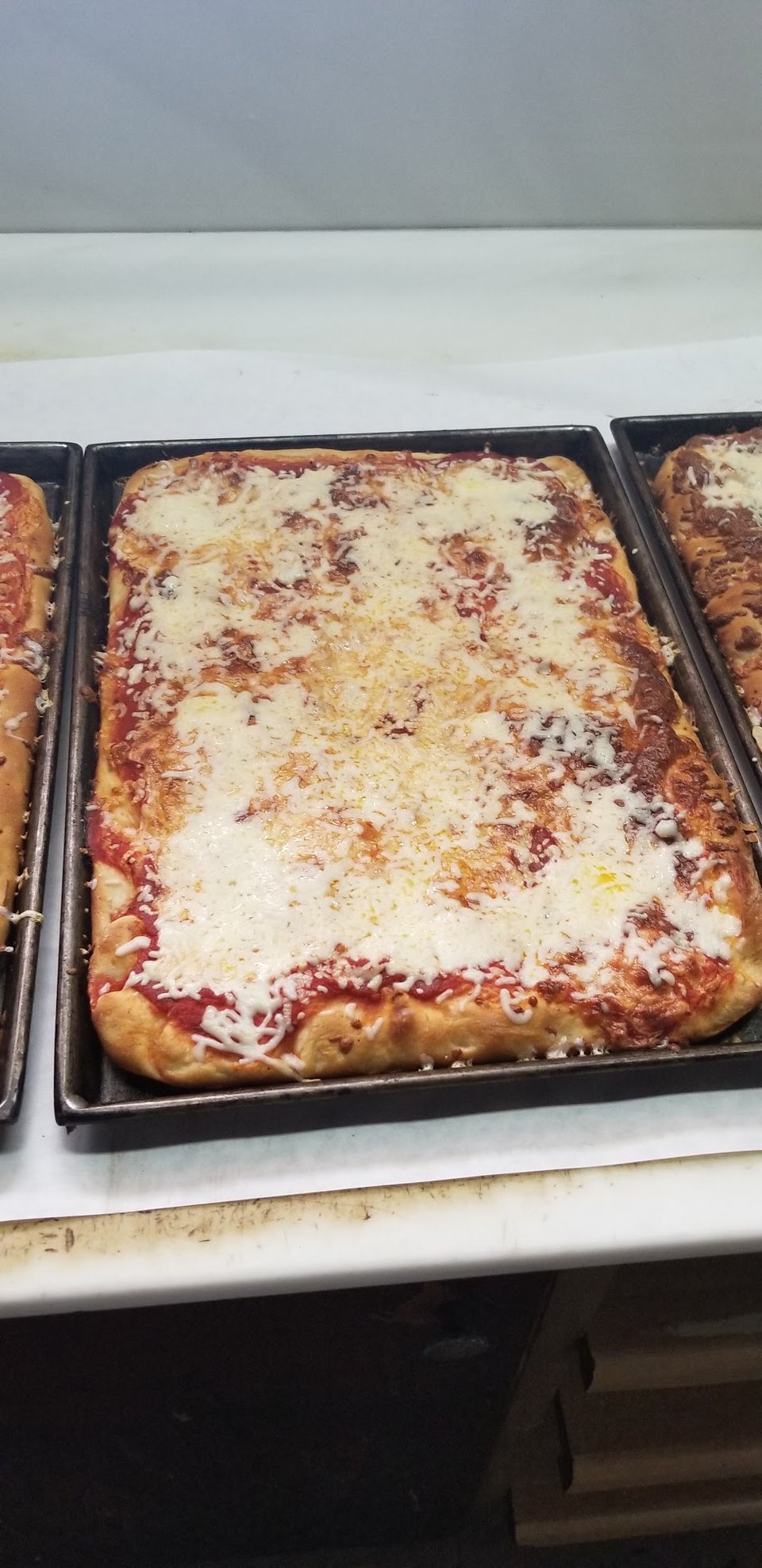 Menu board with pizza and wings.